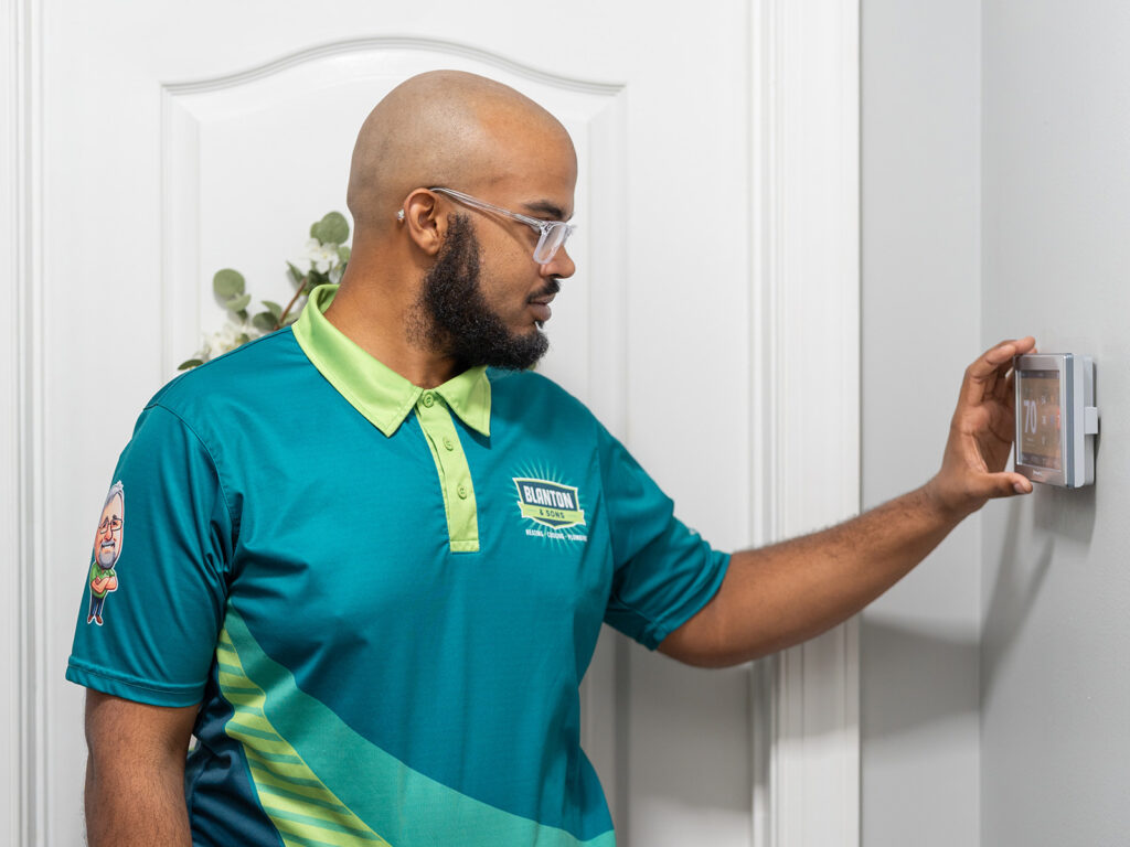 Blanton and Sons tech installing smart thermostat