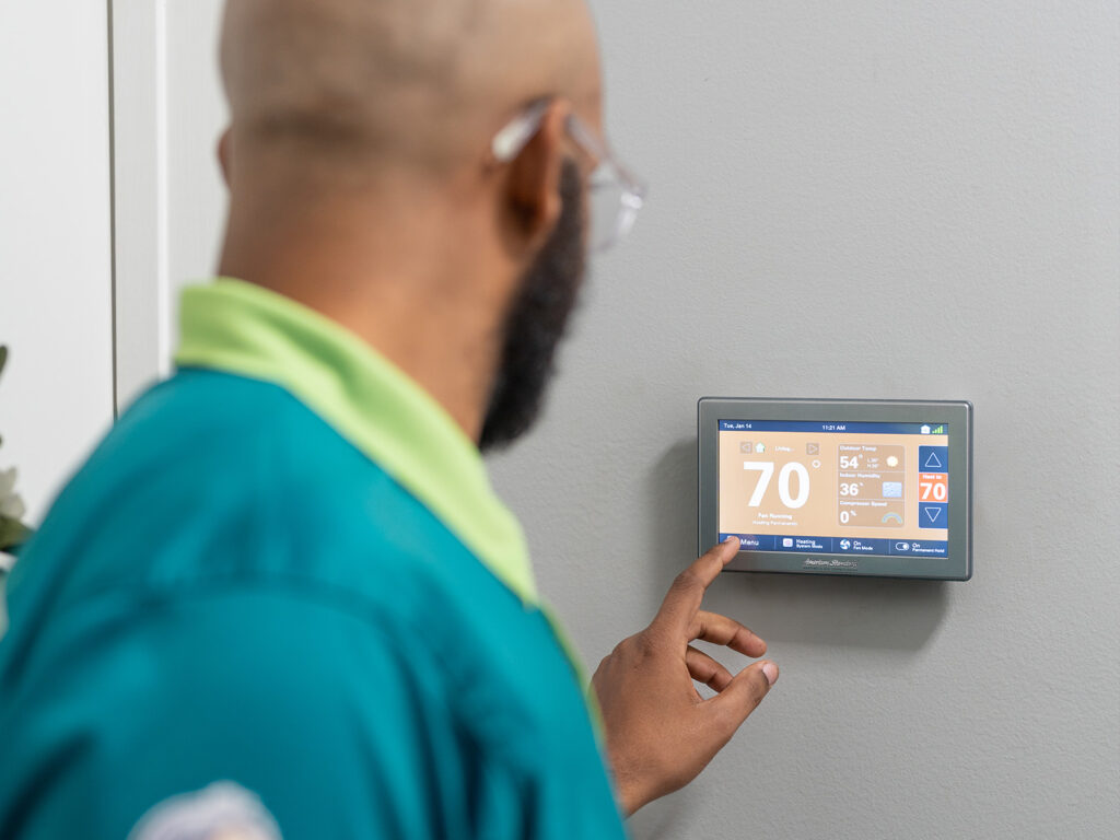 Blanton and Sons tech setting up a smart thermostat
