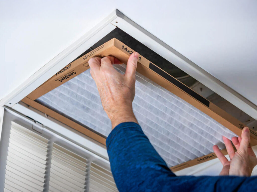 homeowner switching air filter