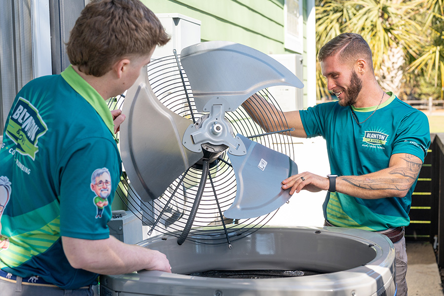 two Blanton's technician installing HVAC unit