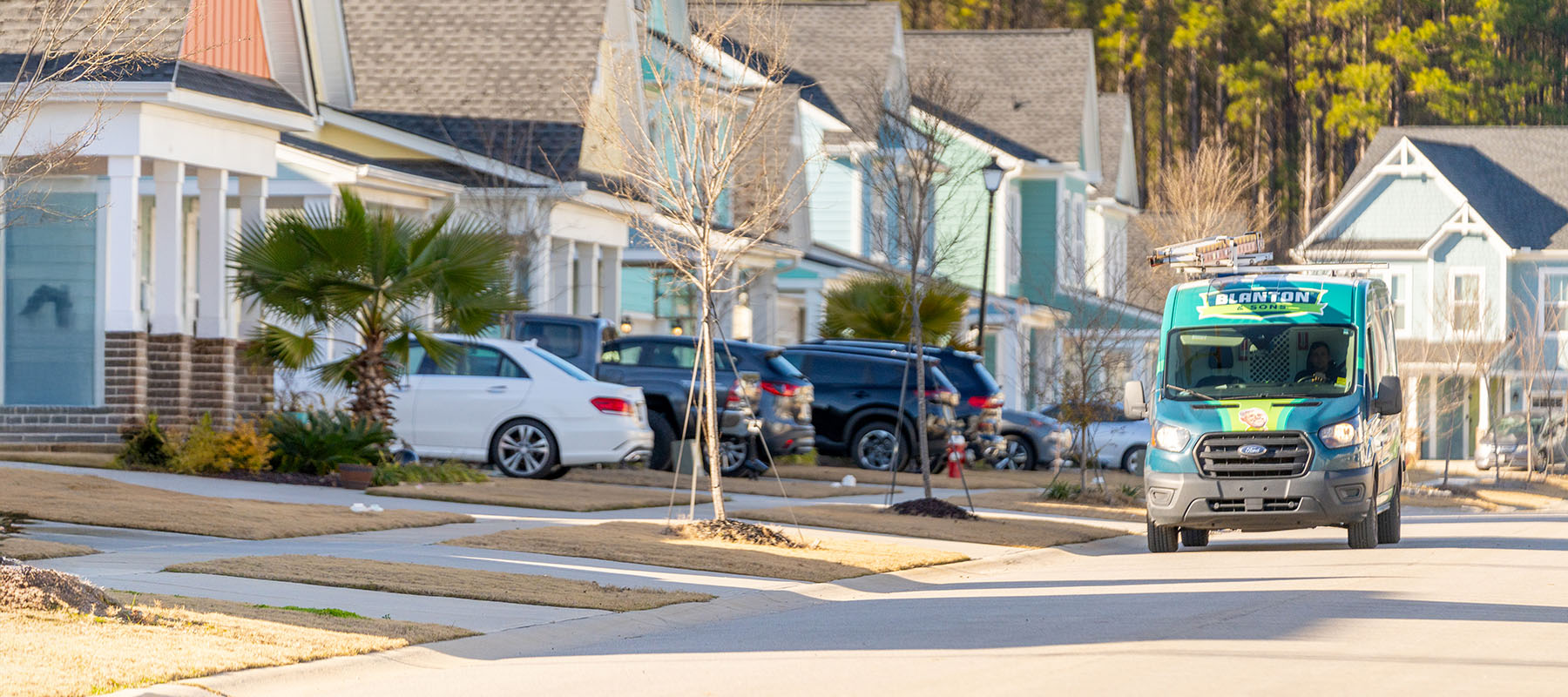 Blanton tech inside branded van driving to residential service call