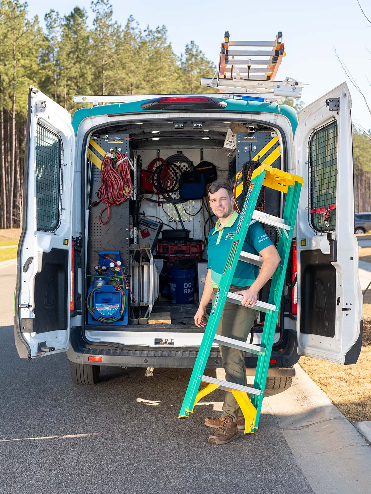 Blanton's technician holding a ladder