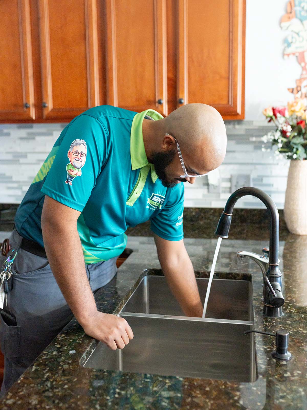Blanton's plumber looking how water goes down the drain in a kitchen sink