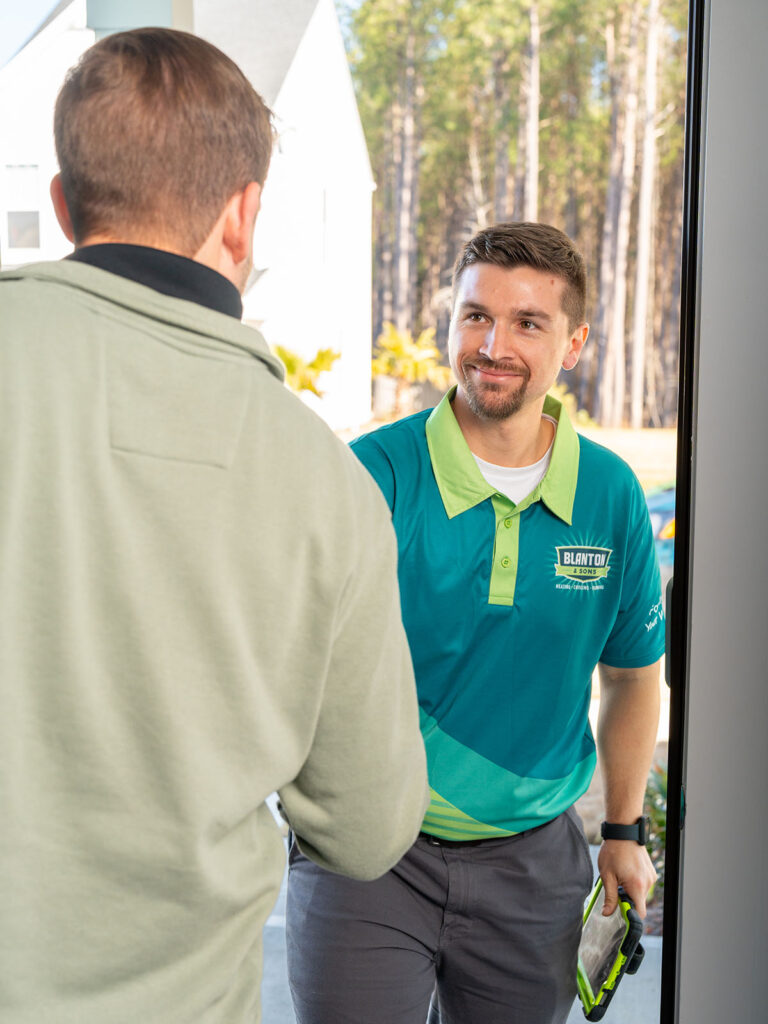 Blanton's technician greeting customer at the door with a handshake.