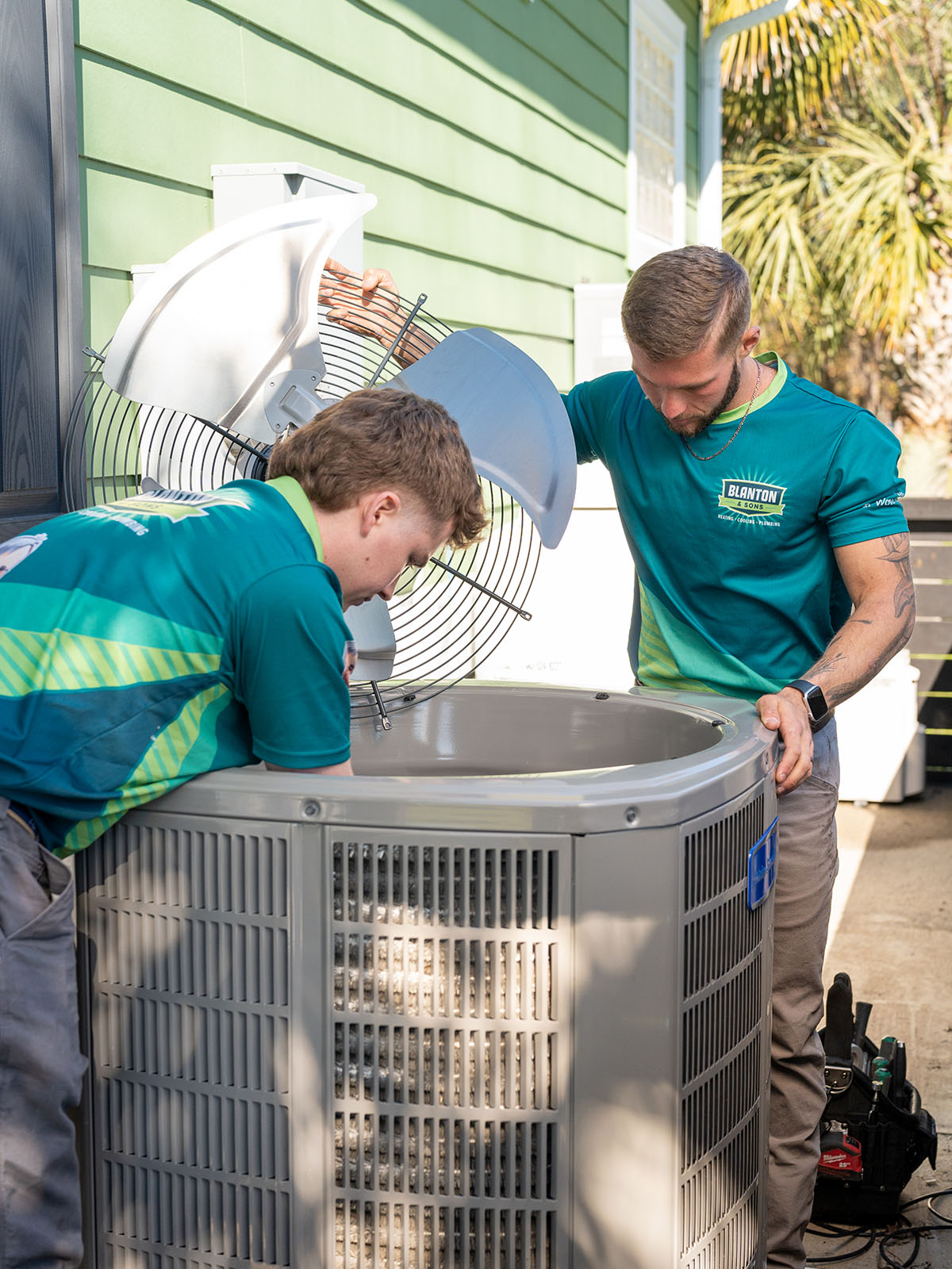 Blanton HVAC tech repairing AC condenser